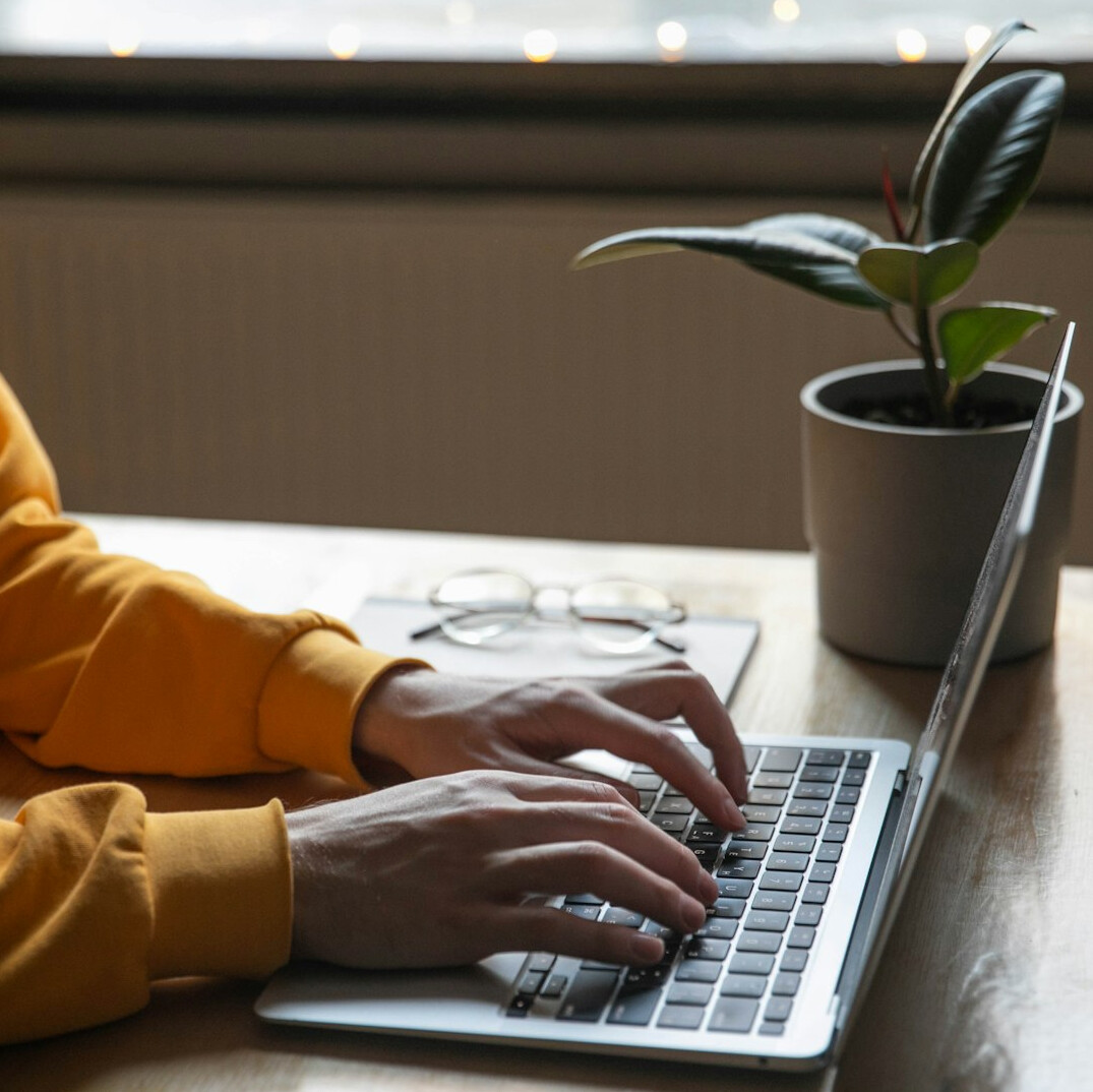 writer typing on laptop